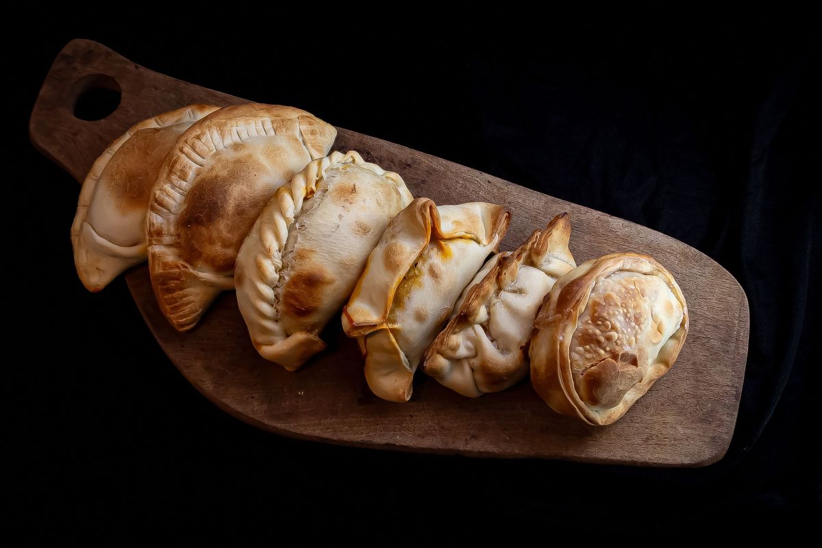 Empanadas doradas sobre una tabla de madera